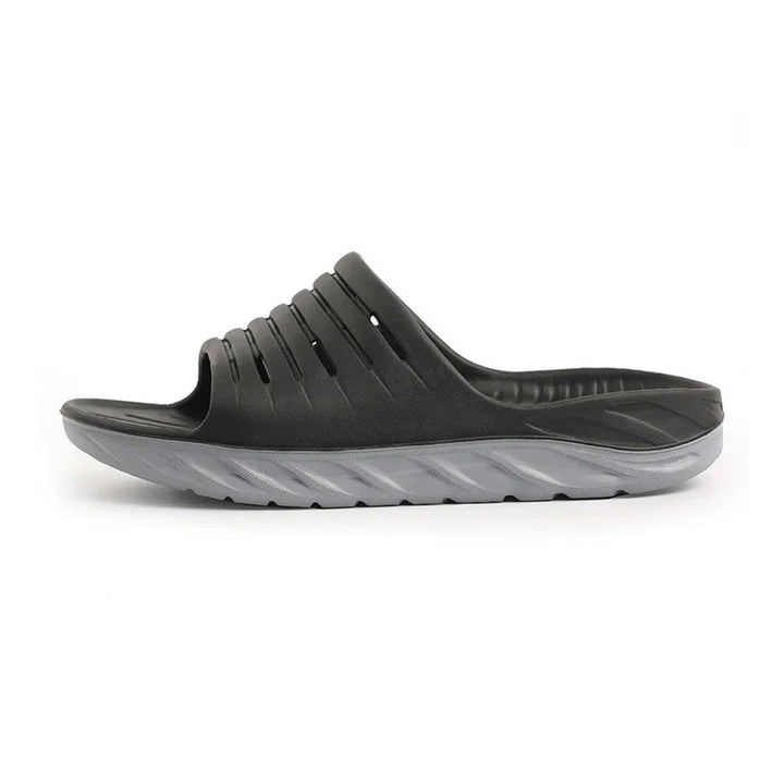 Unisex arch support slides for plantar fasciitis & heel pain relief. Cushioned ergonomic footwear for daily wear comfort.