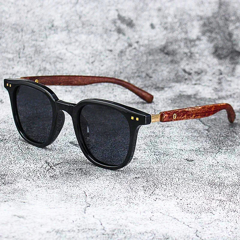 Close-up of Arden unisex sunglasses, showcasing elegant wood-grain temples and dark lenses. Ideal for any outdoor activity.