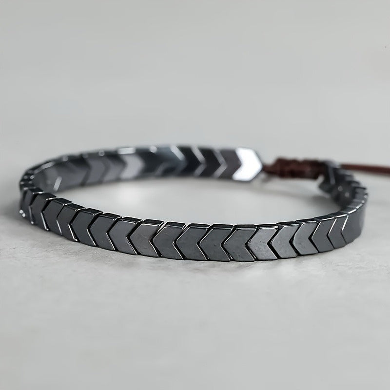 Sleek hematite beaded bracelet with black & grey arrowline pattern, perfect unisex gemstone jewelry.