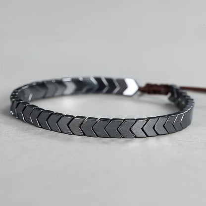 Sleek hematite beaded bracelet with black & grey arrowline pattern, perfect unisex gemstone jewelry.