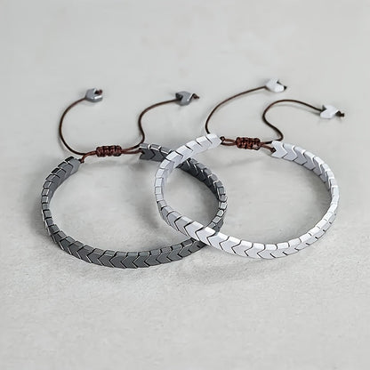 Unisex Arrowline Hematite gemstone bracelet. Adjustable beaded design in black, grey, and silver tones.