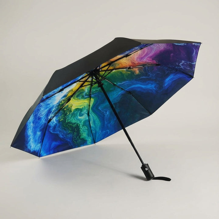 Compact Rainova automatic travel umbrella, open & ready for all weather, durable & waterproof.