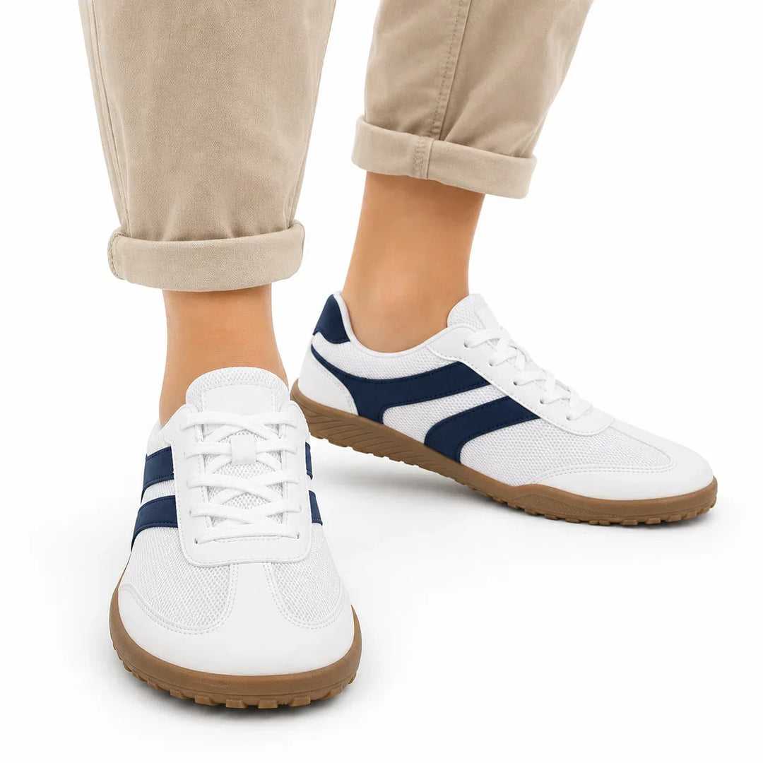 Unisex barefoot walking shoes, wide toe box & non-slip sole, resting on a natural outdoor surface.