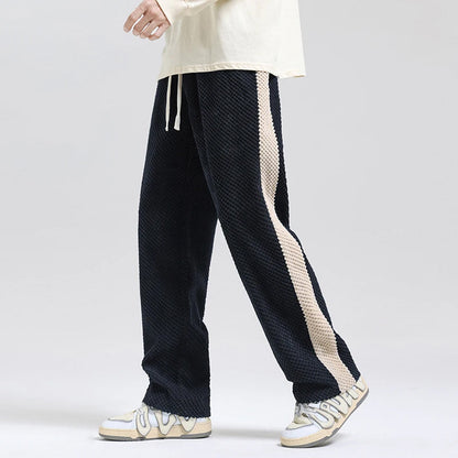 Comfortable black corduroy pants with a relaxed fit, ideal for casual unisex everyday style.