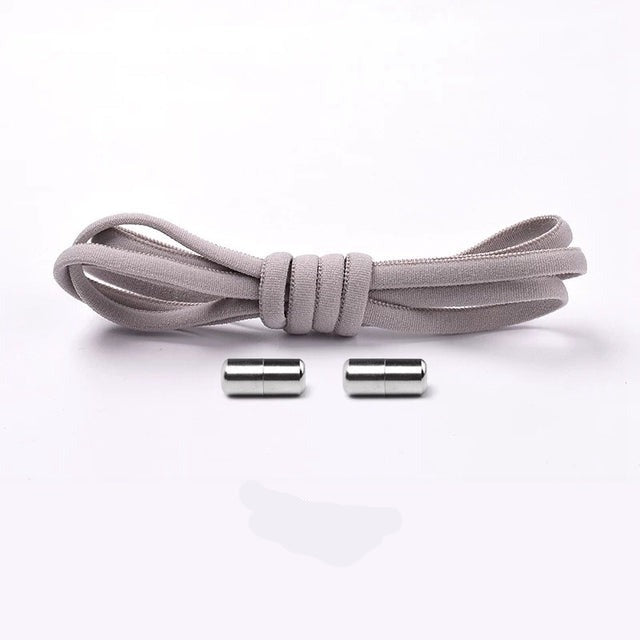 Child easily slipping on shoes with blue elastic no-tie shoelaces, convenience