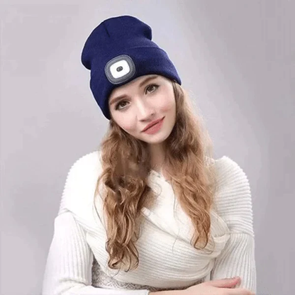 Group of friends wearing different colored LED beanies, enjoying an evening outdoor gathering.