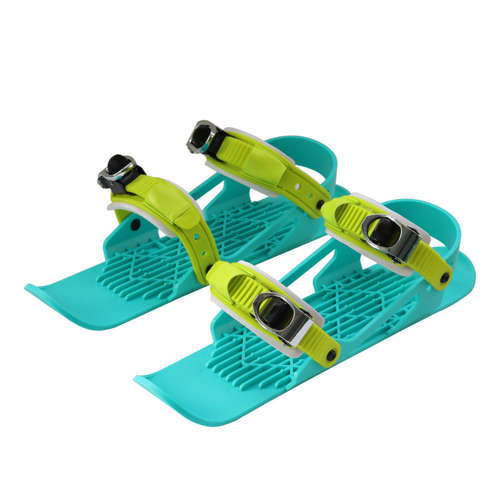 Packaging view of portable mini ski snow skates, emphasizing compact storage and travel readiness