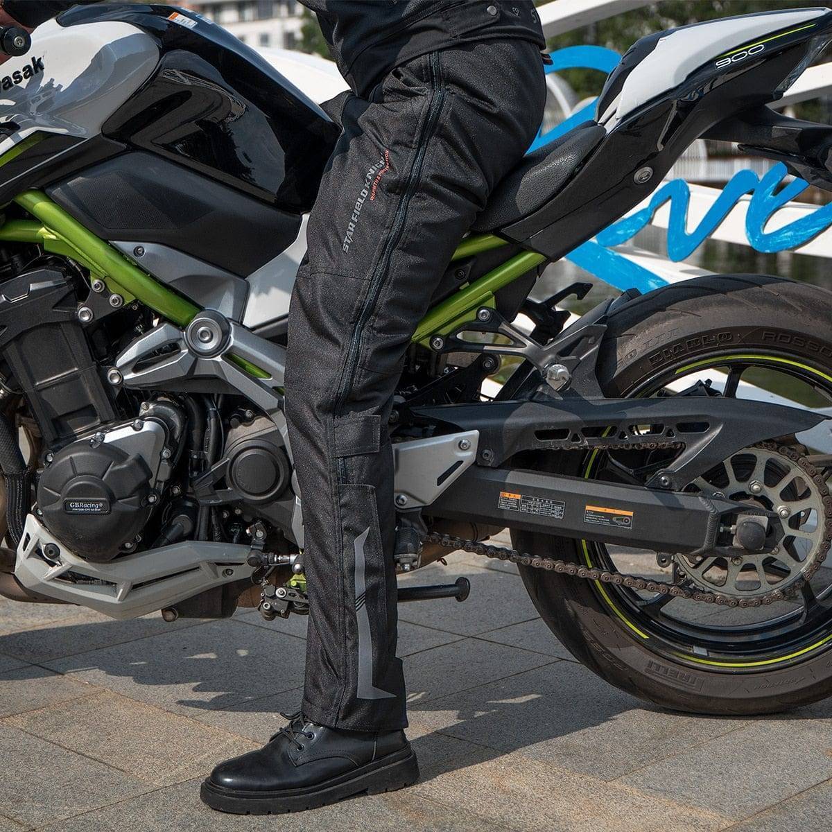 Close-up of quick release buckle on unisex motorcycle cargo pants, showing durable protective gear for riders.