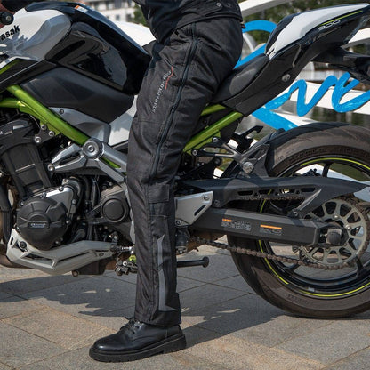 Close-up of quick release buckle on unisex motorcycle cargo pants, showing durable protective gear for riders.