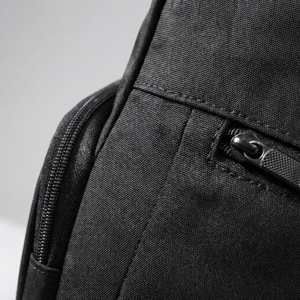 Versatile black unisex roll-top backpack, waterproof, for daily commuting, travel, & secure laptop carry.
