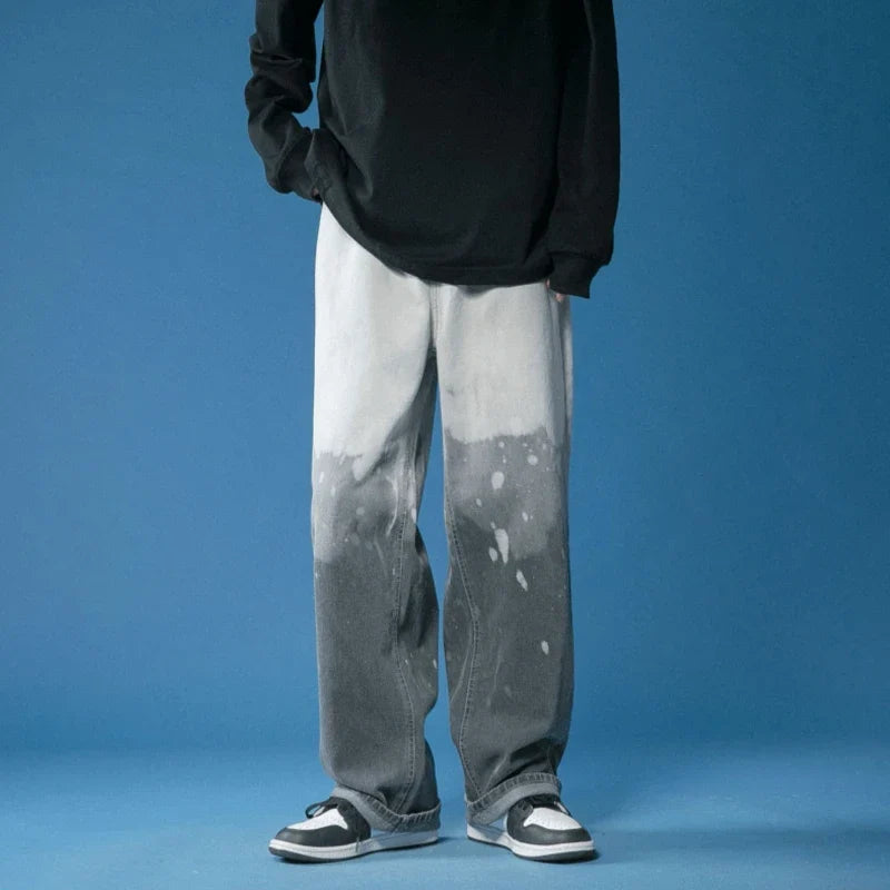 Stylish wide-leg fade jeans with a striking bleach-dye finish, offering a comfortable, relaxed fit for all.