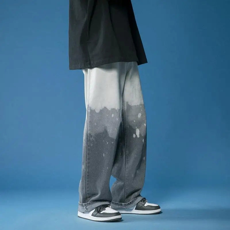 Model showcasing unisex wide-leg fade jeans with a bold bleach-dye design, highlighting a comfortable, relaxed fit.