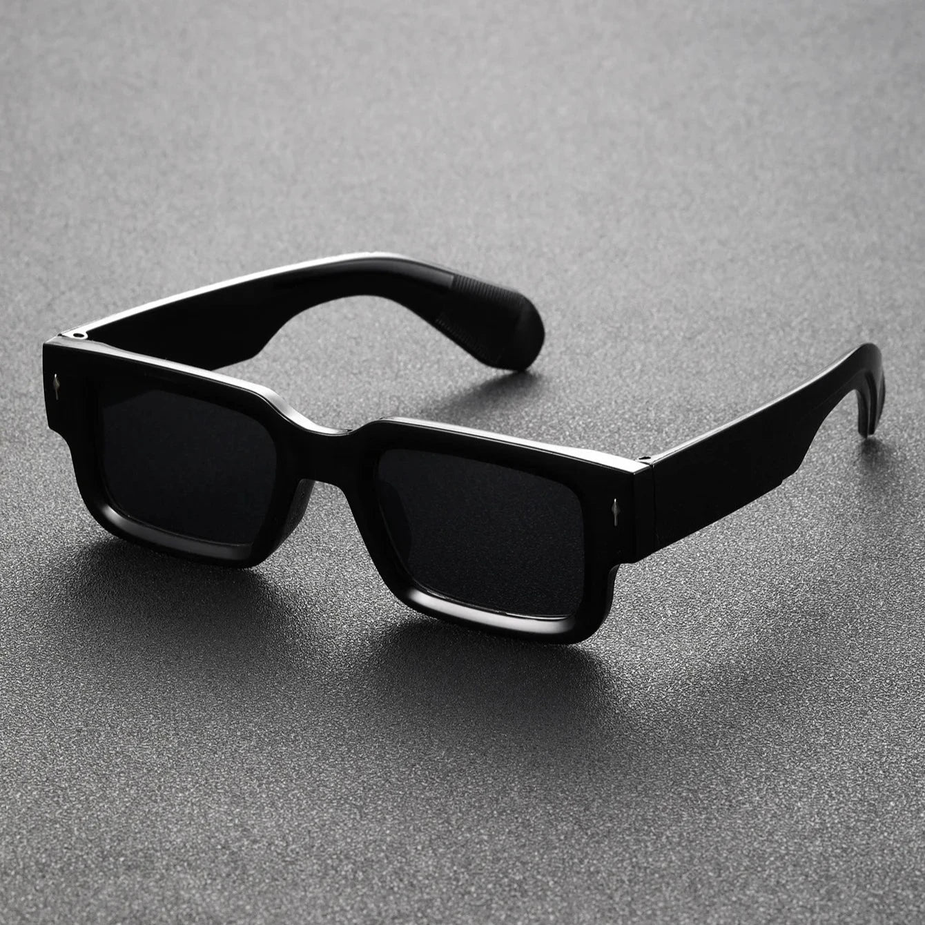 Black translucent rectangular shades offering UV protection. Lightweight unisex eyewear, perfect bold fashion accessory.