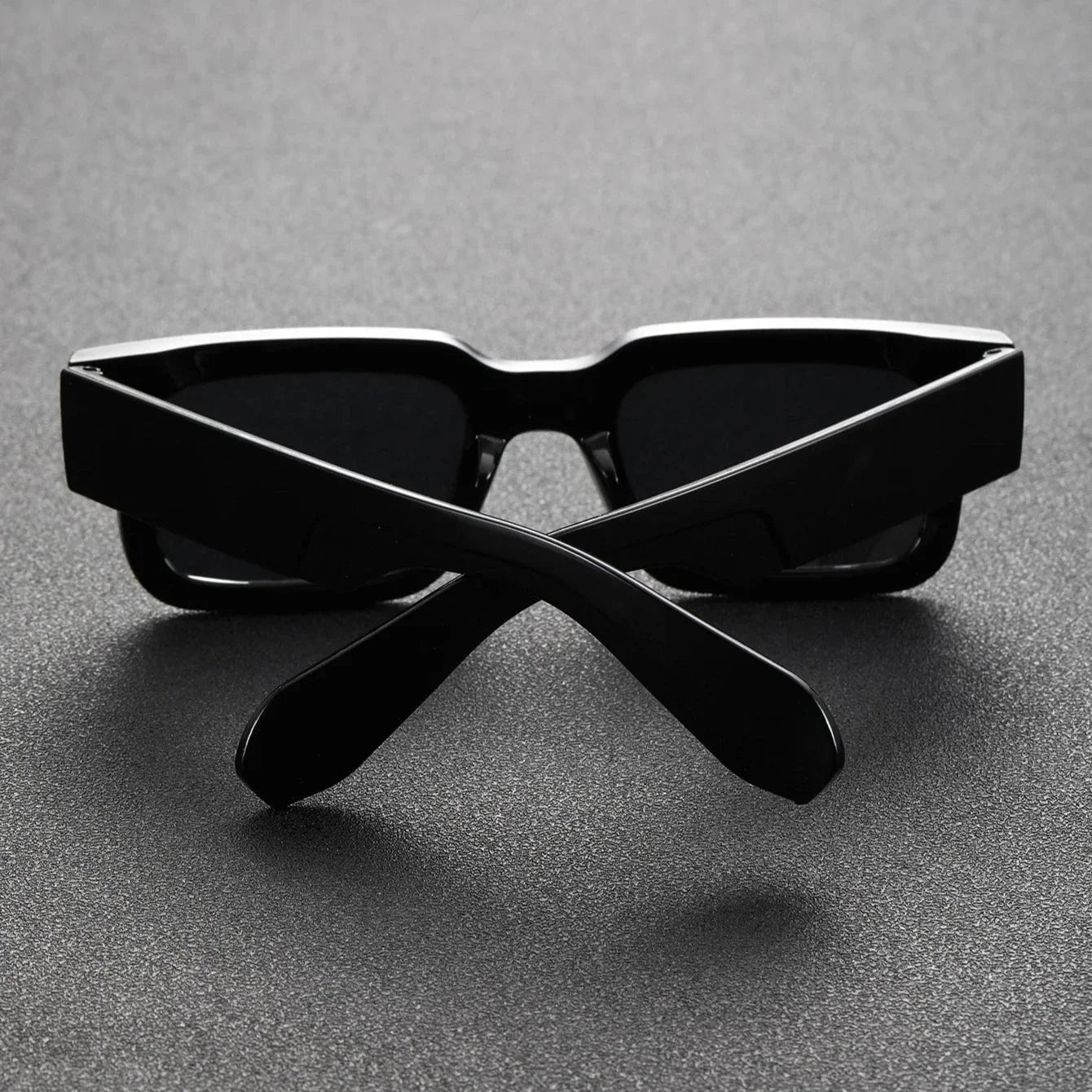 Stylish unisex bold rectangular sunglasses. Translucent black frames with UV protection, a lightweight fashion accessory.