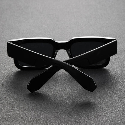 Stylish unisex bold rectangular sunglasses. Translucent black frames with UV protection, a lightweight fashion accessory.