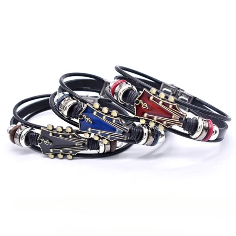 Close-up of a vintage metal guitar charm on a dark genuine leather bracelet, a stylish music-themed accessory.