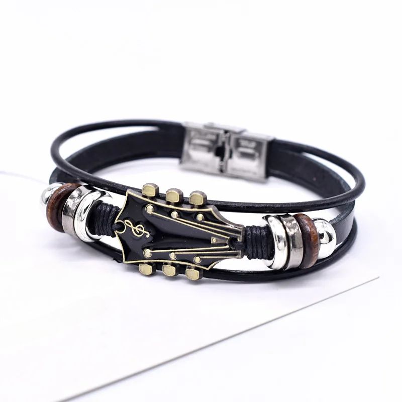Stylish unisex guitar leather bracelet worn on a wrist, a trendy music jewelry accessory for everyday wear.