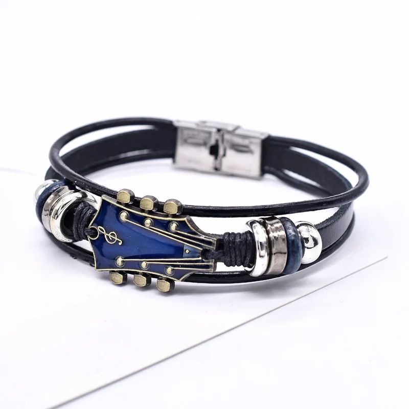 Dark braided genuine leather bracelet featuring a detailed guitar pendant, ideal accessory for musicians & fans.