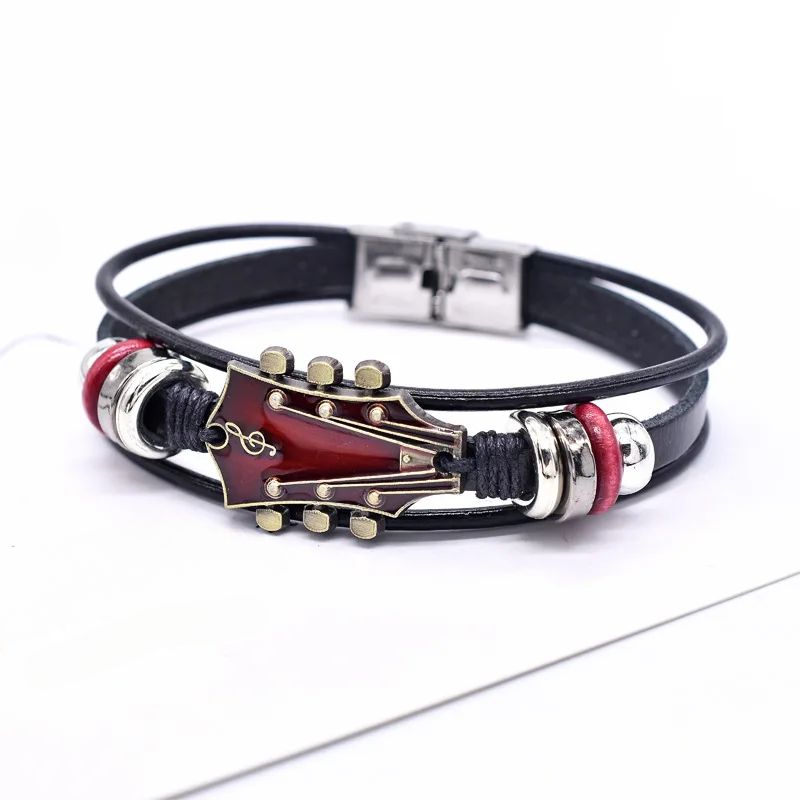 Vintage-style unisex leather bracelet with an intricate guitar charm, a unique music jewelry gift idea.