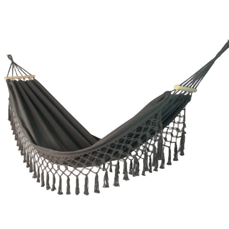 Relaxing anti-rollover canvas hammock for unisex use, featuring wood posts for stability outdoors