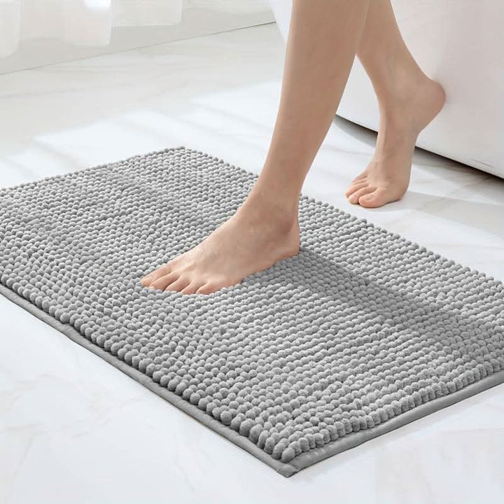 Unisex chenille bath mat for bathroom safety, soft, absorbent, with non-slip backing.