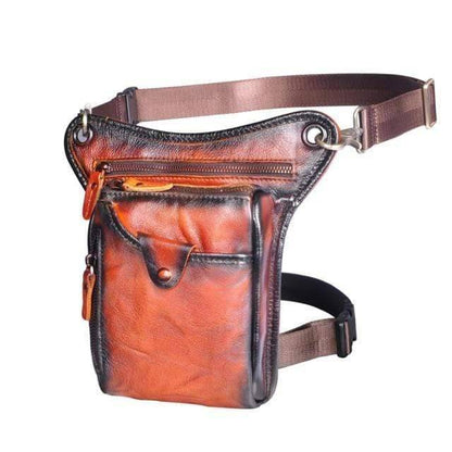 Unisex leather sling bag on a rustic wood background, highlighting genuine cowhide quality