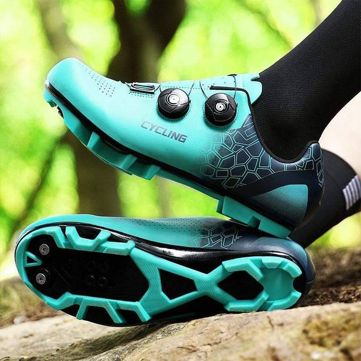 Unisex clipless road cycling shoes, front view. Black with silver accents, ready for biking.