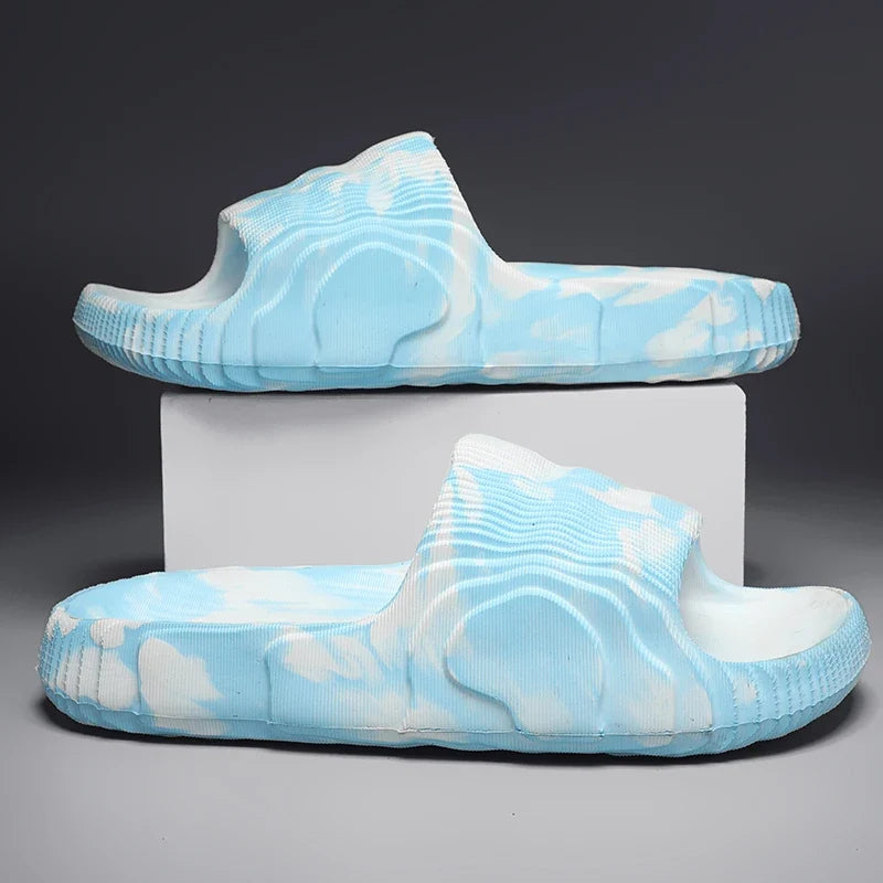 Close-up of Cloud-Soft Rio slides showcasing cushioned sole and marbled, open-toe design for comfort.