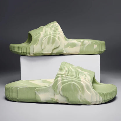 Person wearing unisex Cloud-Soft Rio slides, comfortable open-toe footwear ideal for casual summer style.