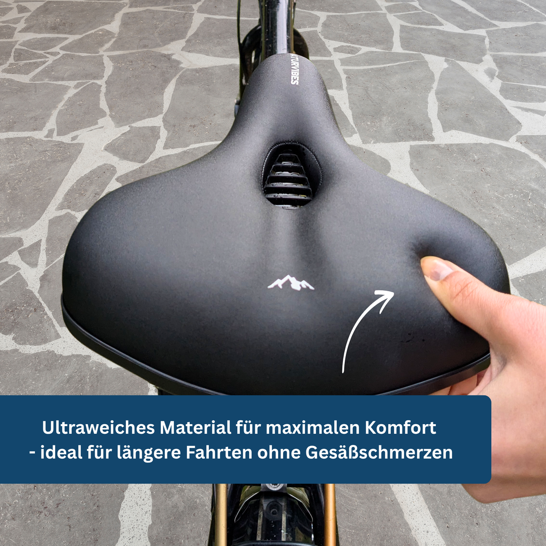 Close-up of a comfort bike saddle featuring soft padding and wide base for unisex cycling