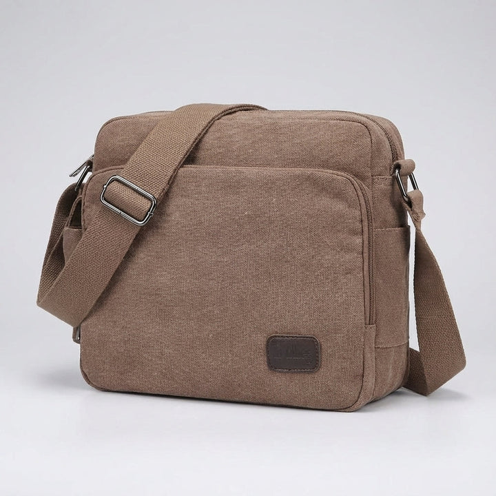 Compact unisex canvas crossbody bag for travel & everyday use. Durable, lightweight design for essentials.