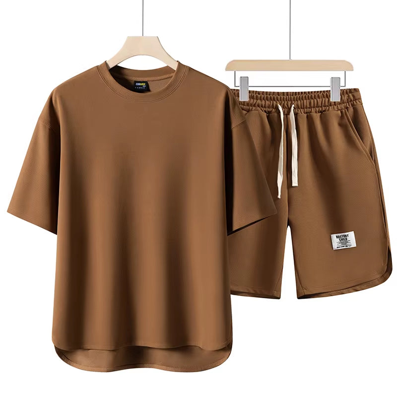 Model wearing a stylish unisex athleisure lounge set. Relaxed fit two-piece for comfort & travel.