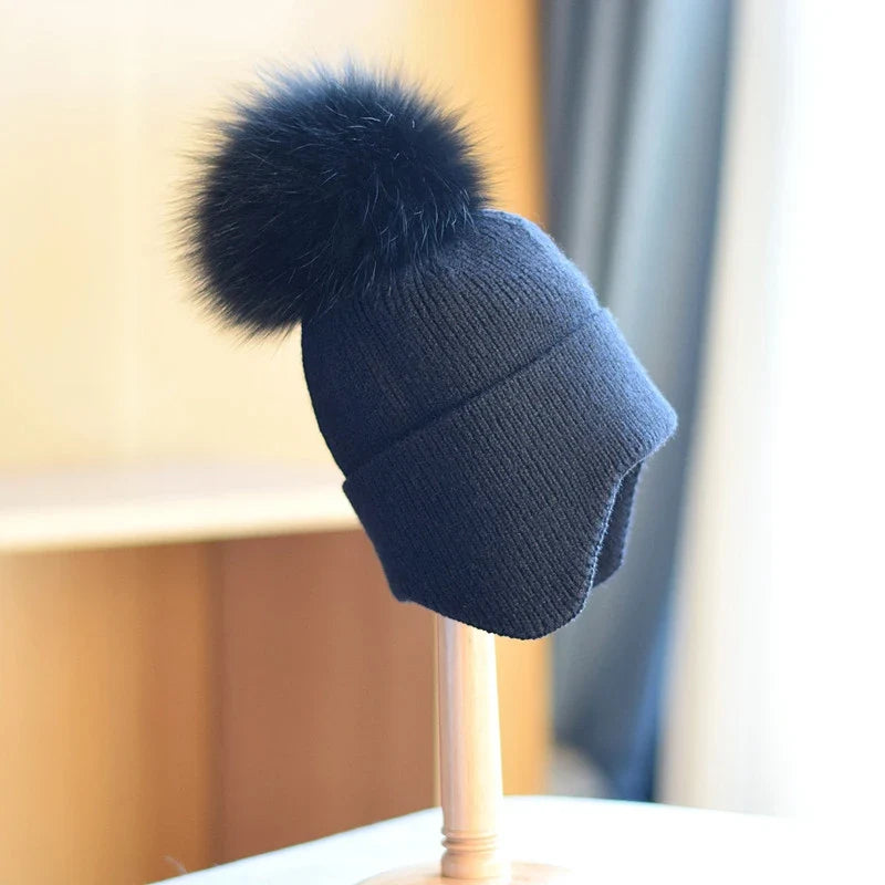 Stylish unisex alpine pom beanie. A cozy, warm winter hat designed for comfortable cold weather headwear.