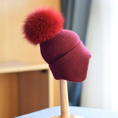 Alpine pom beanie for unisex winter warmth. Essential cozy headwear for cold outdoor adventures and style.