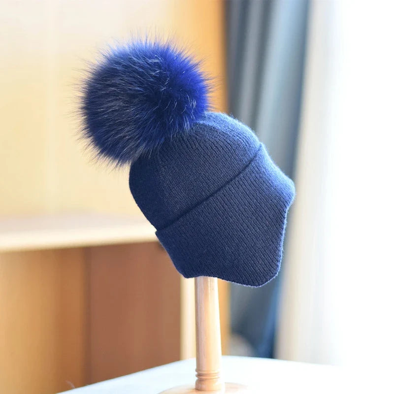 Cozy alpine pom beanie, unisex. Warm winter hat for cold weather, stylish and comfortable outdoor headwear.
