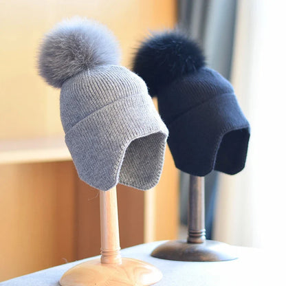 Warm unisex alpine pom beanie. Cozy winter hat, ideal for cold weather, stylish outdoor headwear.