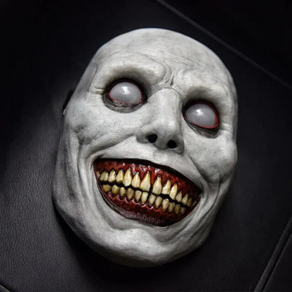Unisex creepy smiling demon mask with disturbing white eyes for Halloween and horror cosplay costumes.