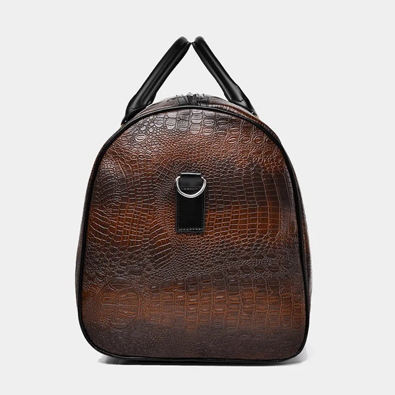 Close-up of luxurious croc-embossed vegan leather texture on a unisex weekender duffle travel bag.