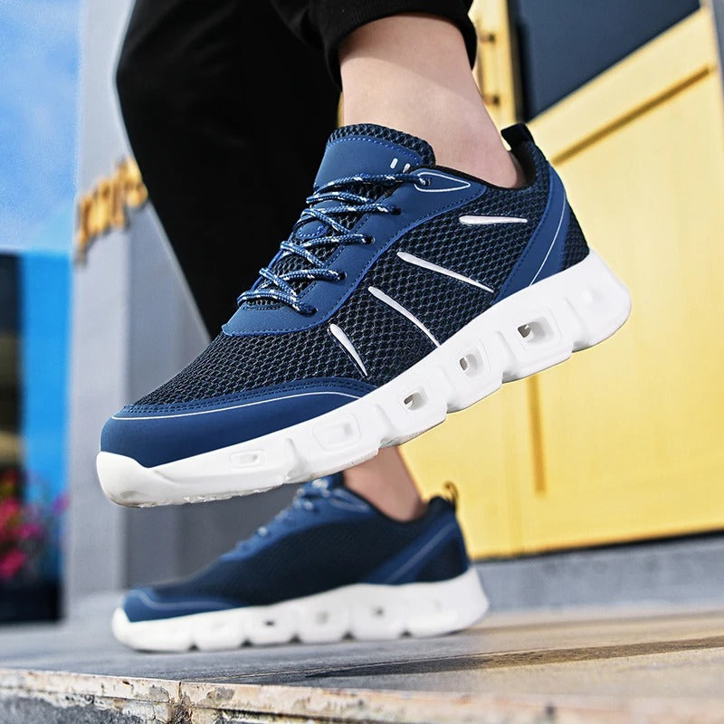 Side view of sleek unisex running shoes, showcasing lightweight design & breathable materials for ultimate comfort.