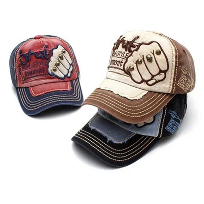 Unisex denim baseball cap featuring bold fist embroidery and metal studs, perfect for edgy street style.