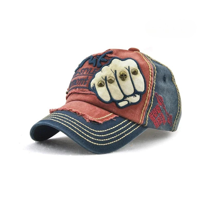 Edgy unisex embroidered cap with a bold fist motif. A stylish denim baseball hat with metal studs.