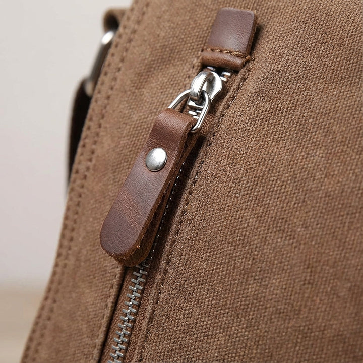 Durable canvas messenger bag with organized compartments. Unisex design for daily essentials & travel.