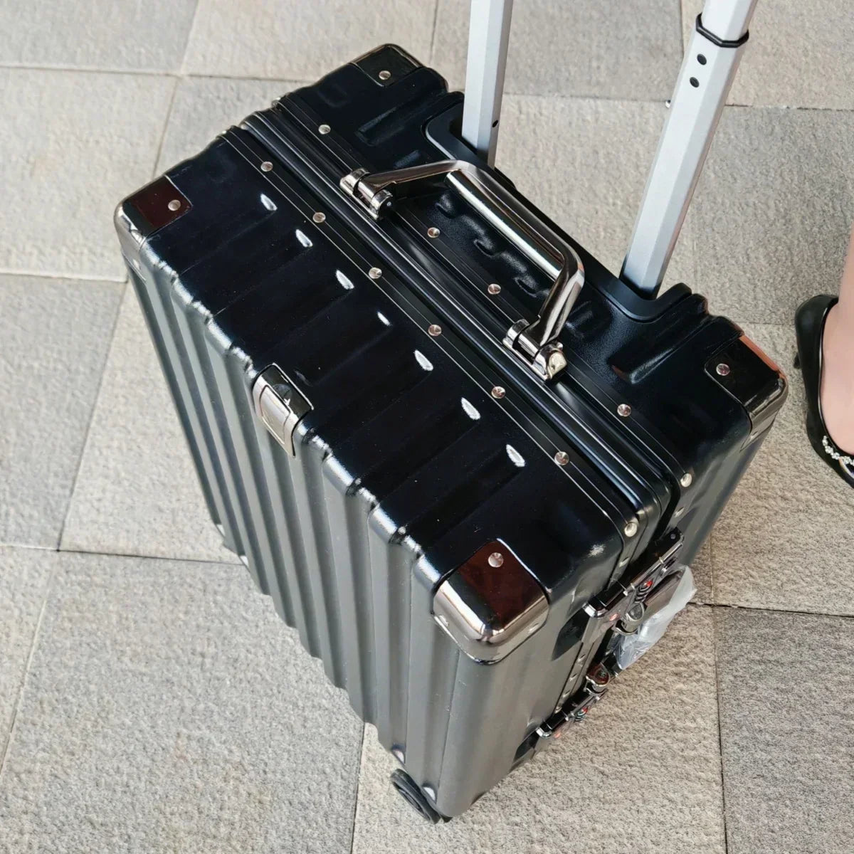 Protective grey travel luggage, 360-degree spinner wheels for easy navigation. Perfect for family vacations.