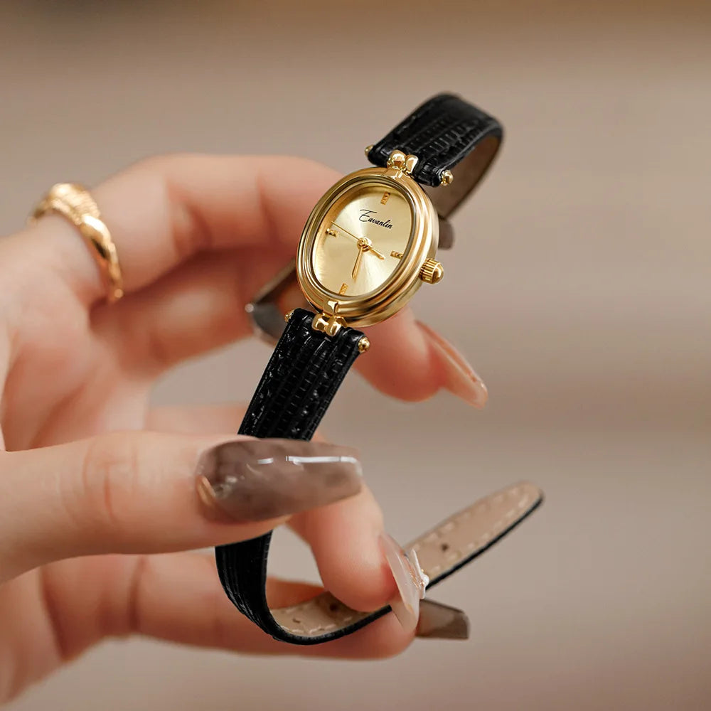 Unisex elegant watch with a sleek black faux leather strap & gold face. A stylish fashion accessory.