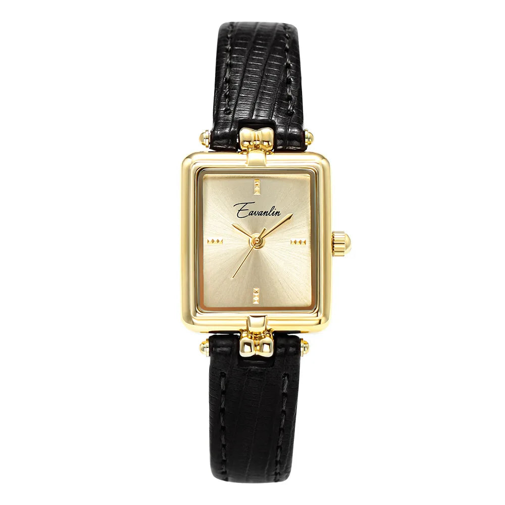 Unisex elegant watch. Black faux leather strap & round gold face on a clean background. Fashion accessory.