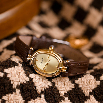 Fashionable unisex watch with a sleek faux leather strap & radiant gold face, enhancing any outfit.