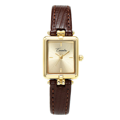 Elegant unisex watch, a formal accessory with a faux leather strap & gold face, complementing a suit.