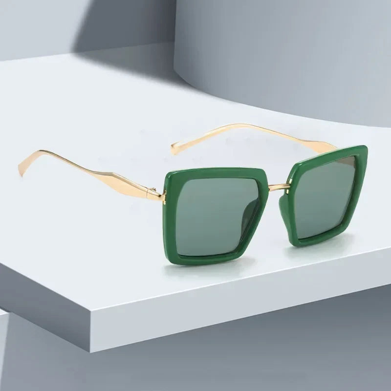 Bold unisex emerald frame square sunglasses with gold accents, offering luxury style & UV protection.