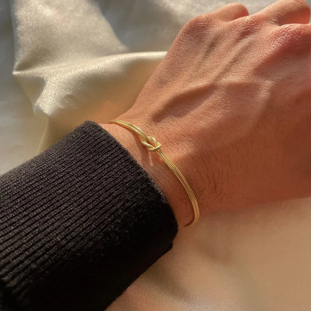 Unisex Endless Knot stainless steel chain bracelet, adjustable, minimalist symbolic jewelry for men & women.