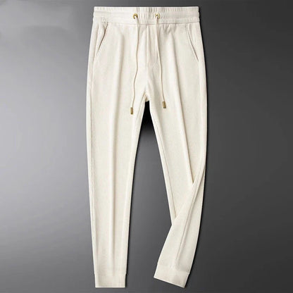 Close-up of luxe gold details on drawstring & pocket zipper of unisex everyday comfort pants.
